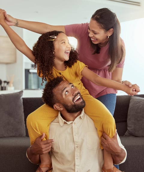 Father, mother and daughter playing with each other at home